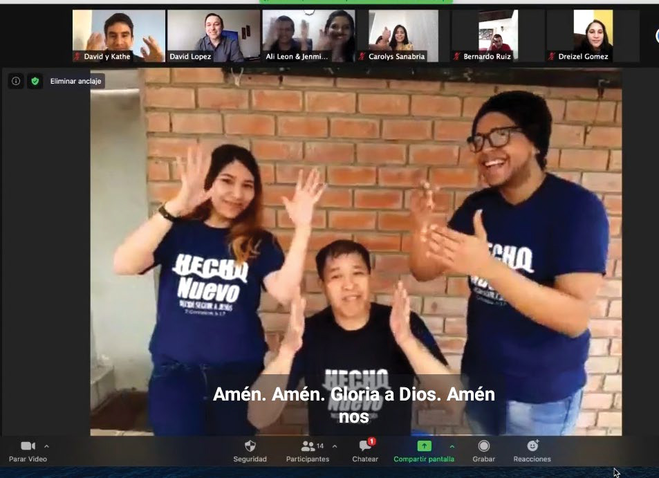 Rosa, Felix, and another leader clap in sign language after Felix's baptism