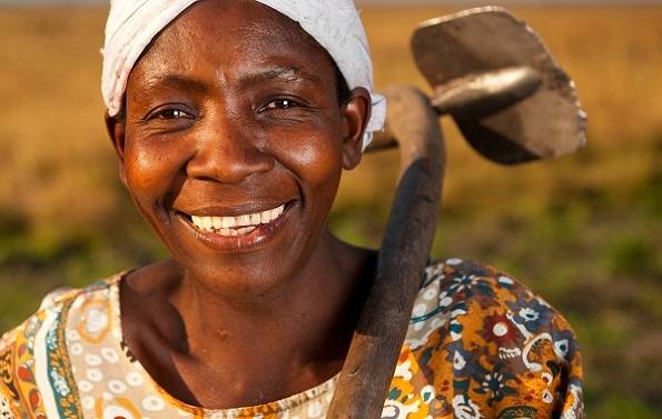 Agatha Akakandelwa working in her tomato field in Nambinji Village